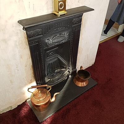 cast fireplace refurbished and fitted with slate hearth