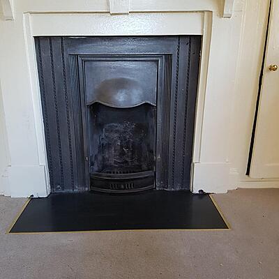 Small cast fireplace