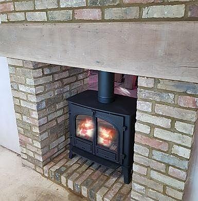 Double sided Wood Burning stove with brick chamber and heath