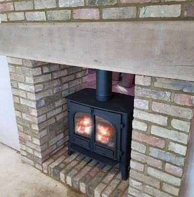 Double sided Wood Burning stove with brick chamber and heath
